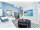 Bright, open living room with modern furniture, high ceilings, and a large flat screen television at 6005 N Beach Rd # 16, Englewood, FL 34223