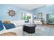 Open living room with comfortable seating, nautical decor, and great natural light providing an inviting and airy atmosphere at 6005 N Beach Rd # 16, Englewood, FL 34223