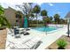 Relaxing community pool surrounded by lush landscaping and lounge chairs, perfect for sunny days at 6005 N Beach Rd # 16, Englewood, FL 34223
