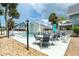 Community pool with chairs and tables, perfect for relaxing in the sun at 6005 N Beach Rd # 16, Englewood, FL 34223