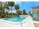 Gorgeous community pool surrounded by palm trees at 6005 N Beach Rd # 16, Englewood, FL 34223