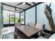 Charming screened porch with modern furniture, ceiling fans and views of the outdoors at 6005 N Beach Rd # 16, Englewood, FL 34223