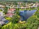 Wide aerial view of community homes nestled around a large pond at 6610 Rosy Barb Ct, Lakewood Ranch, FL 34202