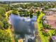 Stunning aerial perspective of a home next to a tranquil pond, capturing the essence of peaceful suburban living at 6610 Rosy Barb Ct, Lakewood Ranch, FL 34202