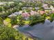 Aerial view of a lovely home with a pool, surrounded by mature trees and a scenic pond, blending luxury and nature at 6610 Rosy Barb Ct, Lakewood Ranch, FL 34202