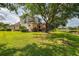 Spacious backyard with mature tree, views of lake, and lush green grass at 6610 Rosy Barb Ct, Lakewood Ranch, FL 34202