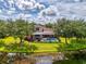 Beautiful backyard with a screened pool, lush lawn and pond view at 6610 Rosy Barb Ct, Lakewood Ranch, FL 34202