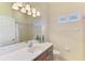 Bright bathroom features a vanity with solid surface countertops and modern lighting fixtures over the mirror at 6610 Rosy Barb Ct, Lakewood Ranch, FL 34202