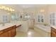 Bright bathroom with soaking tub, walk-in shower, and double vanity with granite countertop at 6610 Rosy Barb Ct, Lakewood Ranch, FL 34202