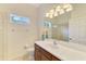 Bright bathroom features a vanity with solid surface countertops and modern lighting fixtures over the mirror at 6610 Rosy Barb Ct, Lakewood Ranch, FL 34202