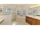 Bathroom featuring soaking tub, glass enclosed shower and cherry wood cabinets at 6610 Rosy Barb Ct, Lakewood Ranch, FL 34202