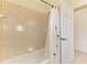 Bathroom featuring tiled shower and bathtub, with a white shower curtain and tiled walls at 6610 Rosy Barb Ct, Lakewood Ranch, FL 34202