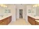 Spacious bathroom with double sinks and wood cabinets, and tiled floor at 6610 Rosy Barb Ct, Lakewood Ranch, FL 34202