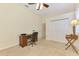 Bedroom area with a desk, ceiling fan, closet, and a window with shutters at 6610 Rosy Barb Ct, Lakewood Ranch, FL 34202