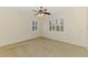 Spacious bedroom features two shuttered windows, a ceiling fan and neutral carpet at 6610 Rosy Barb Ct, Lakewood Ranch, FL 34202