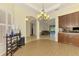 Dining room with hardwood flooring, modern chandelier, and adjacent to kitchen and living spaces at 6610 Rosy Barb Ct, Lakewood Ranch, FL 34202