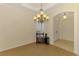 Bright dining area with modern lighting fixture, hardwood floors, and adjacent entry at 6610 Rosy Barb Ct, Lakewood Ranch, FL 34202