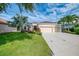 Lush green lawn and mature landscaping enhance this property's curb appeal and charm at 6610 Rosy Barb Ct, Lakewood Ranch, FL 34202