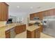 Bright kitchen features stainless steel appliances, granite countertops, and tile floors at 6610 Rosy Barb Ct, Lakewood Ranch, FL 34202