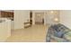 Open-concept living room with tile floors, comfortable seating, and view of the kitchen and entry at 6610 Rosy Barb Ct, Lakewood Ranch, FL 34202