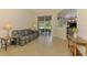 Inviting living room with tile flooring, comfortable seating, and sliding glass doors to the outdoors at 6610 Rosy Barb Ct, Lakewood Ranch, FL 34202