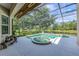 Screened-in pool area with a lake view and spa at 6610 Rosy Barb Ct, Lakewood Ranch, FL 34202