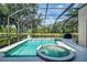 Relaxing screened-in pool and hot tub overlooking a serene lake view at 6610 Rosy Barb Ct, Lakewood Ranch, FL 34202