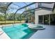 Beautiful screened-in pool and spa overlooking the lush backyard and pond, perfect for relaxation and entertainment at 6610 Rosy Barb Ct, Lakewood Ranch, FL 34202