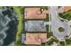 Aerial view of luxury homes with pools, tile roofs, and manicured landscaping near a lake at 7634 Windy Hill Cv, Bradenton, FL 34202