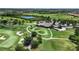 Aerial view of the community's golf course, clubhouse, and landscaping at 7634 Windy Hill Cv, Bradenton, FL 34202