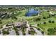 Golf clubhouse featuring a well-manicured golf course, lake and ample parking at 7634 Windy Hill Cv, Bradenton, FL 34202