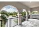 Charming balcony offers a beautiful view of a landscaped neighborhood and palm trees at 7634 Windy Hill Cv, Bradenton, FL 34202