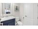 Stylish half bathroom with modern fixtures and a charming octopus art piece on the wall at 7634 Windy Hill Cv, Bradenton, FL 34202