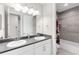 Well-lit bathroom with double sinks, granite countertops, and modern fixtures at 7634 Windy Hill Cv, Bradenton, FL 34202