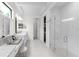 Clean and bright bathroom featuring double vanity sinks, walk-in shower, and sleek modern design at 7634 Windy Hill Cv, Bradenton, FL 34202