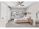 Bright bedroom with natural light, a pink bed, and a charming balcony view at 7634 Windy Hill Cv, Bradenton, FL 34202