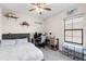Inviting bedroom featuring an organized desk space, neutral tones and a ceiling fan at 7634 Windy Hill Cv, Bradenton, FL 34202