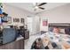 Bedroom with ceiling fan, posters, gray carpet, a window and bed with geometric patterned quilt at 7634 Windy Hill Cv, Bradenton, FL 34202
