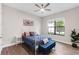 Cozy bedroom featuring an ornate white bed frame, ceiling fan, and bright natural light at 7634 Windy Hill Cv, Bradenton, FL 34202