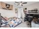 Bedroom with ceiling fan, gray carpet, and bed with geometric patterned quilt and a West Point banner at 7634 Windy Hill Cv, Bradenton, FL 34202