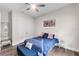 Comfortable bedroom boasts a plush blue bench, white nightstands, and stylish floral wall art at 7634 Windy Hill Cv, Bradenton, FL 34202