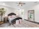 Elegant bedroom features a tufted headboard and large mirror, creating a bright and inviting space at 7634 Windy Hill Cv, Bradenton, FL 34202