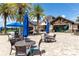 Clubhouse patio with outdoor seating and lush tropical landscaping at 7634 Windy Hill Cv, Bradenton, FL 34202