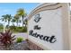 Entrance sign for 'The Retreat' with landscaping and palm trees at 7634 Windy Hill Cv, Bradenton, FL 34202
