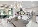 Dining room with modern lighting and open floor plan showcasing the kitchen and living spaces at 7634 Windy Hill Cv, Bradenton, FL 34202