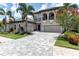 Beautiful home with a paved driveway, a two-car garage, and well-maintained landscaping at 7634 Windy Hill Cv, Bradenton, FL 34202