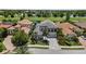 Charming two-story home with well-manicured landscaping, paver driveway, and a tile roof at 7634 Windy Hill Cv, Bradenton, FL 34202