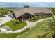 Aerial view of the clubhouse with meticulous landscaping and golf course at 7634 Windy Hill Cv, Bradenton, FL 34202