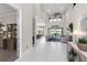 Inviting foyer with high ceilings leading to an open living space with golf course views at 7634 Windy Hill Cv, Bradenton, FL 34202