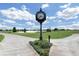 Ornate clock tower surrounded by flowerbeds on a beautifully maintained golf course at 7634 Windy Hill Cv, Bradenton, FL 34202